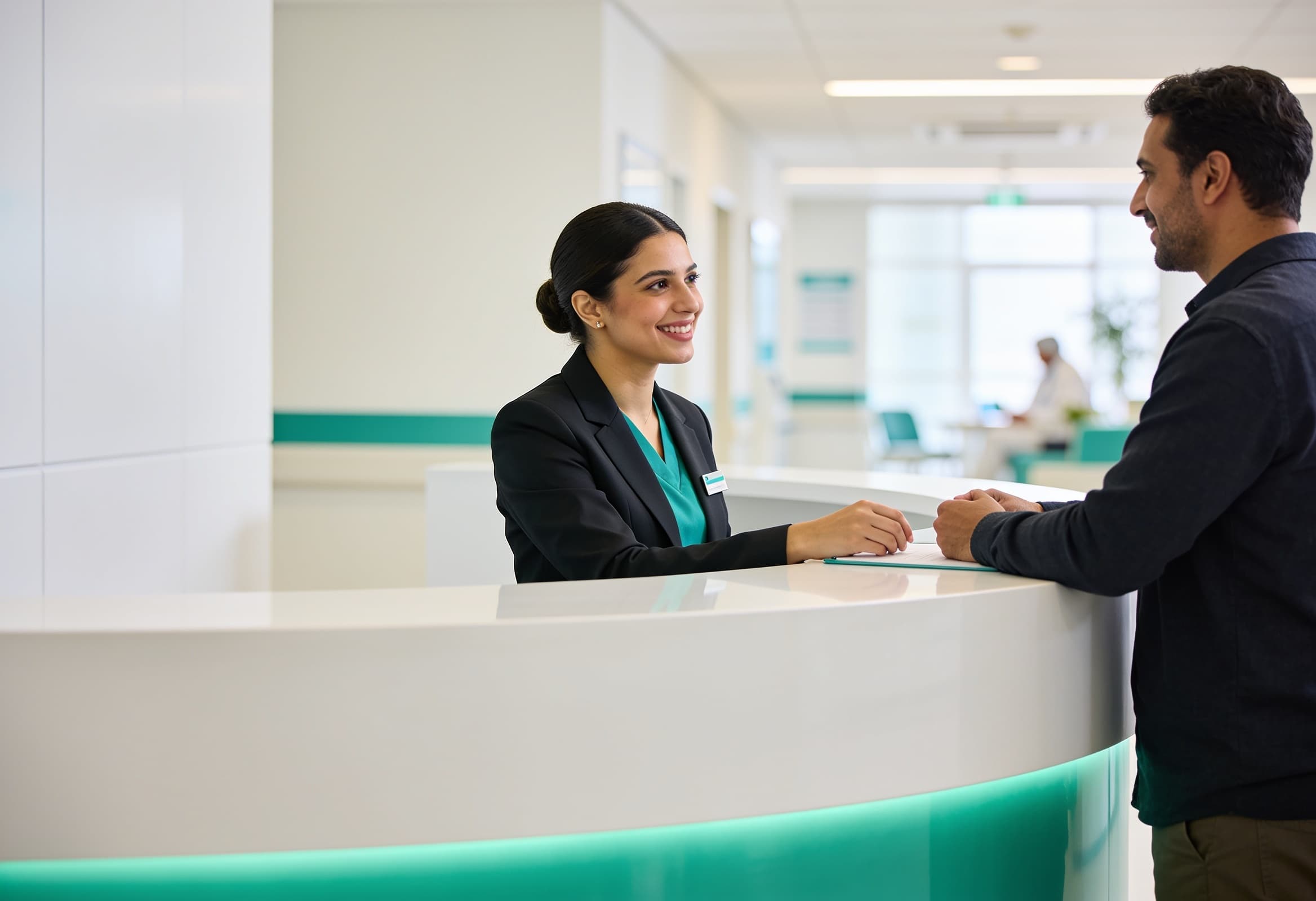 A friendly clinic receptionist in the UAE assisting a patient at a modern front desk