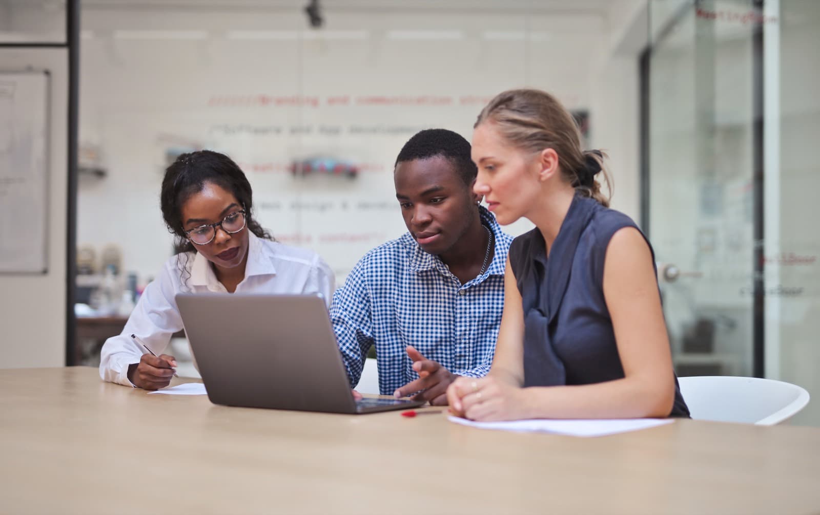 A business team reviewing performance data together in a modern office